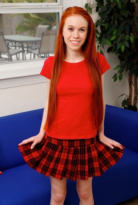Cute redhead Dolly Spice peels off her tartan skirt and panties to model naked 51779656